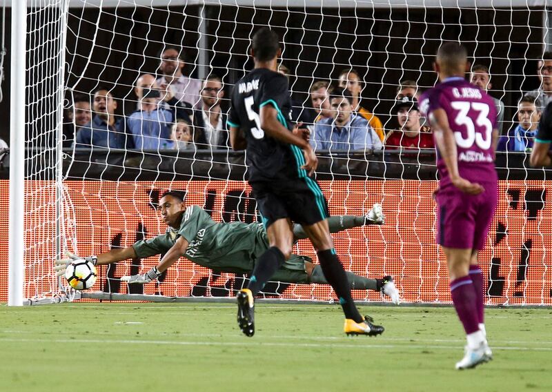 Real Madrid goalkeeper Keylor Navas, left, makes a save against Manchester City. Ringo Chiu / AFP