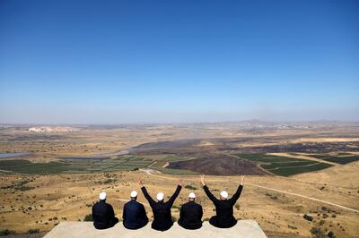 FILE PHOTO: Israeli Druzes sit together watching the Syrian side of the Israel-Syria border on the Israeli-occupied Golan Heights, Israel July 7, 2018. REUTERS/Ronen Zvulun/File Photo