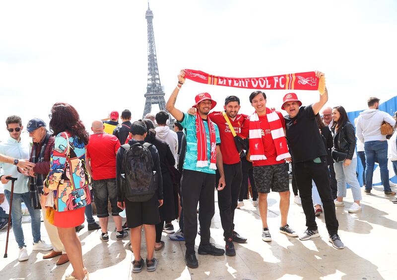 A group of Liverpool fans pose for a photograph in front of the Eiffel Tower. Getty