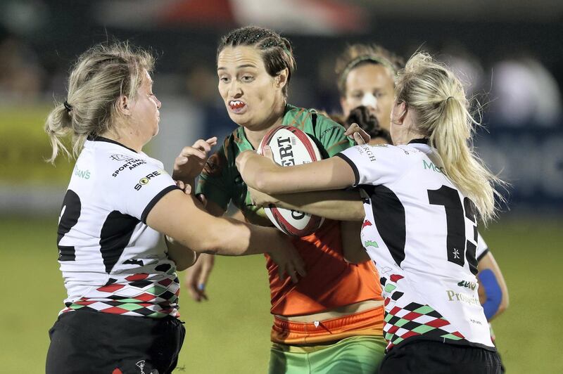 Dubai, United Arab Emirates - December 05, 2019: Holly Murphy of Knights Eagles takes on the Quins defence in the match between Dubai Knights Eagles and Abu Dhabi Harlequins in the Gulf womens at the HSBC rugby sevens series 2020. Thursday, December 5th, 2019. The Sevens, Dubai. Chris Whiteoak / The National