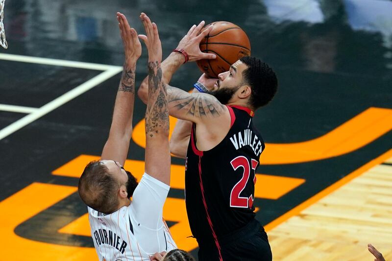 Toronto Raptors guard Fred VanVleet, right, goes up against Orlando Magic guard Evan Fournier for a shot during the second half of an NBA basketball game, Tuesday, Feb. 2, 2021, in Orlando, Fla. (AP Photo/John Raoux)