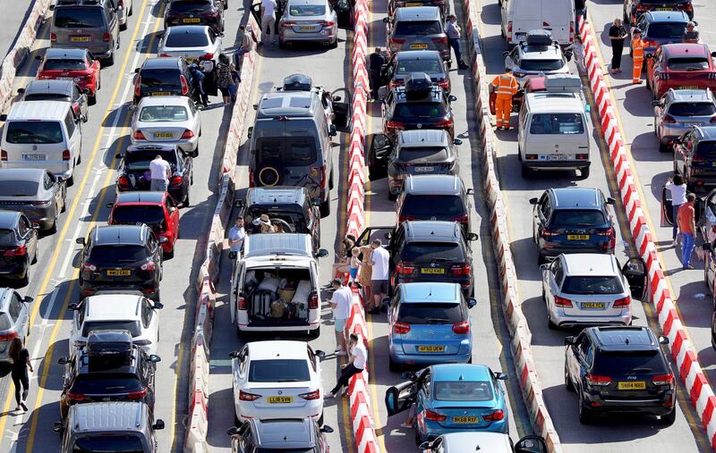 Passengers queue for ferries at the Port of Dover, during the hot weather, in Kent, England. PA via AP