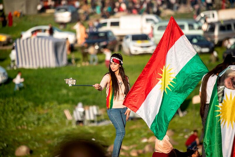 A woman poses for a selfie during the celebration of Nowruz in Al Qahtaniyah, in the Hasakeh province near the Syrian-Turkish border. AFP