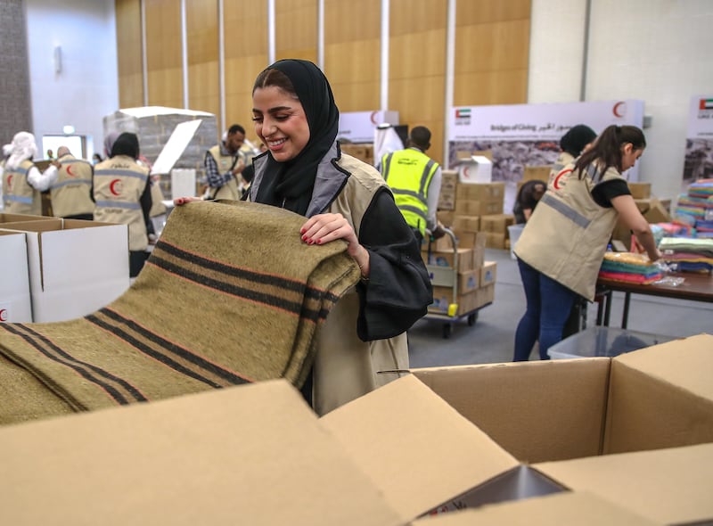 Volunteers pack food, blankets and other essential goods at Adnec, in Abu Dhabi. All photos: Victor Besa / The National