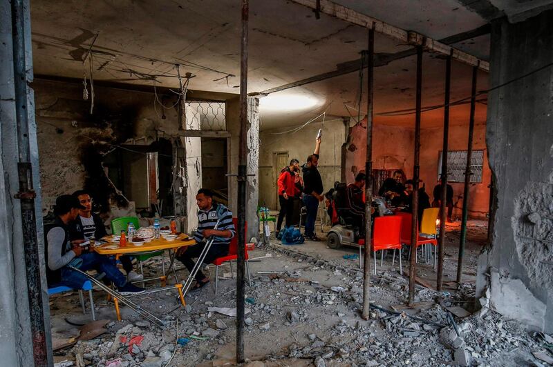 Palestinian amputees break their fast at a community centre that was destroyed during the escalation with Israel, in Rafah. AFP