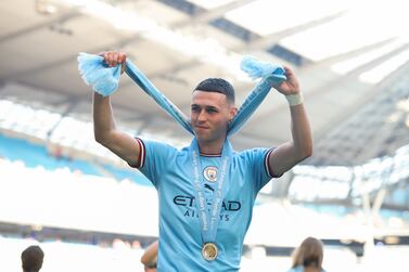MANCHESTER, ENGLAND - MAY 21: Phil Foden of Manchester City acknowledges the fans as they celebrate whilst wearing his Premier League Winners Medal after the Premier League match between Manchester City and Chelsea FC at Etihad Stadium on May 21, 2023 in Manchester, England. (Photo by Catherine Ivill / Getty Images)