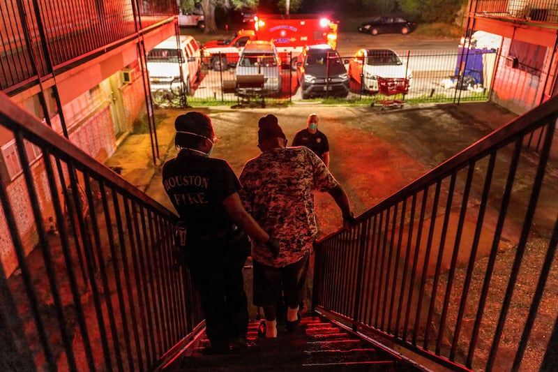 Medics transport a Covid-positive patient to a hospital in Houston, Texas. AFP