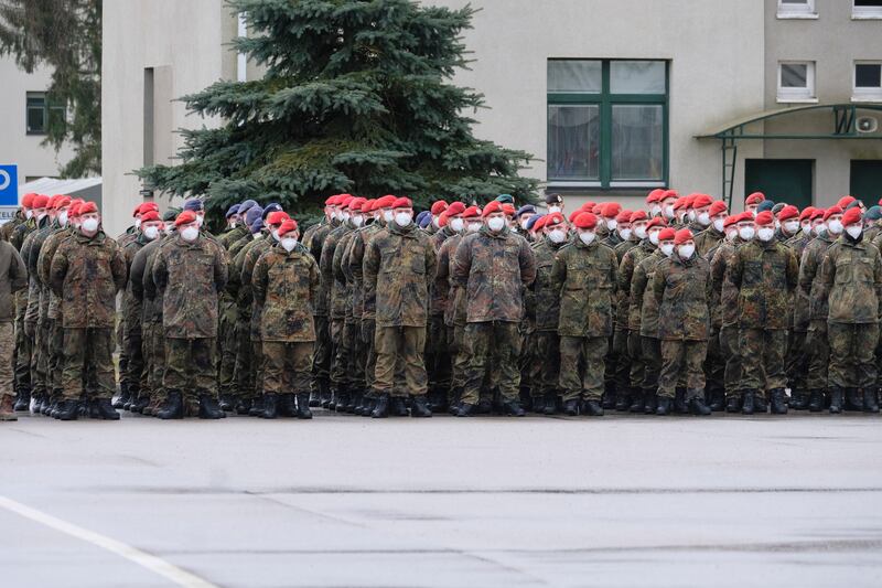 German soldiers of the Nato enhanced Forward Presence (EFP) Battalion Battle Group in Lithuania attend a ceremony during a visit of German Defence Minister Christine Lambrecht to Rukla Military Base, Lithuania, on February 22. EPA