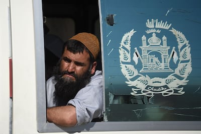 A Taliban prisoner looks out from a window of a vehicle during his release from the Bagram prison, next to the US military base in Bagram, some 50 km north of Kabul. Afghan authorities plan to release 900 more Taliban prisoners on May 26, as calls grow for the militants to extend a ceasefire on its third and final day. / AFP / WAKIL KOHSAR
