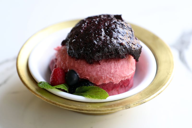 Red passion goat's milk ice cream from Mado, made up of layers of strawberry, blackberry, rose berry and pomegranate. 
