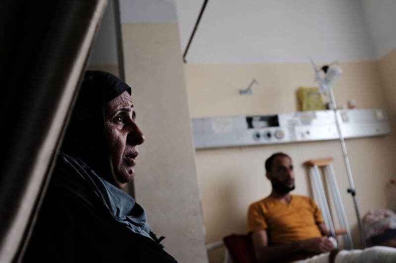 GAZA CITY, GAZA - MAY 10:  A mother sits with her son who was shot in the leg at the border fence by an Israeli sniper,  at Shifa Hospital in Gaza on May 10, 2018 in Gaza City, Gaza. Tensions are high along the Gaza-Israel border following more than a month of weekly mass protests near the fence that has left 40 Palestinian protesters killed and over 1,700 wounded by Israeli army fire. Gaza's Hamas rulers have vowed that the marches will continue until the decade-old Israeli blockade of the territory is lifted. Protests are expected this Friday, as well as on May 14 and 15, the day Palestinians mark the Yawm an-Nakba or "Day of Catastrophe", to commemorate the anniversary of their mass uprooting during the 1948 war over Israel's creation.  (Photo by Spencer Platt/Getty Images)