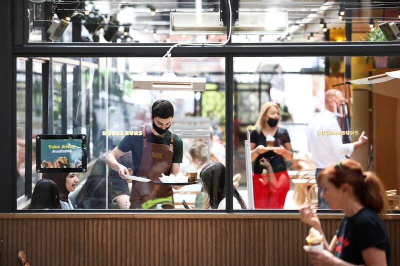 People sit inside a restaurant in Covent Garden, in London. Reuters