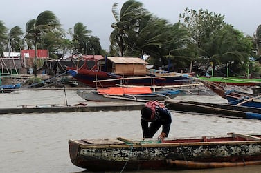 A Fisherman secures a boat in anticipation of an approaching typhoon in the town of Calabanga, Camarines sur province, Philippines, 2 December 2019. EPA/JONNEL MARIBOJOC