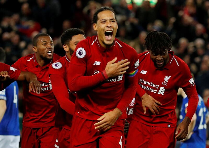 FILE PHOTO: Soccer Football - Premier League - Liverpool v Everton - Anfield, Liverpool, Britain - December 2, 2018  Liverpool's Divock Origi celebrates scoring their first goal with Virgil van Dijk and team mates  REUTERS/Phil Noble  EDITORIAL USE ONLY. No use with unauthorized audio, video, data, fixture lists, club/league logos or "live" services. Online in-match use limited to 75 images, no video emulation. No use in betting, games or single club/league/player publications.  Please contact your account representative for further details./File Photo