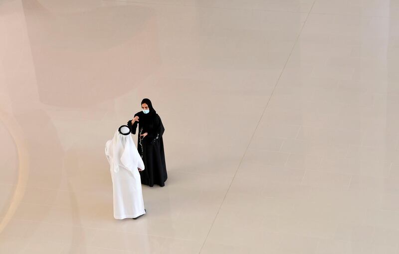 Emiratis wearing protective masks amid the Covid-19 pandemic chat in a hall at Mohammed bin Rashid University in Dubai.   AFP