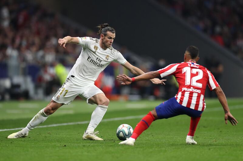 MADRID, SPAIN - SEPTEMBER 28: Gareth Bale of Real Madrid battles for the ball with Renan Lodi of Atletico Madrid during the Liga match between Club Atletico de Madrid and Real Madrid CF at Wanda Metropolitano on September 28, 2019 in Madrid, Spain. (Photo by Angel Martinez/Getty Images)