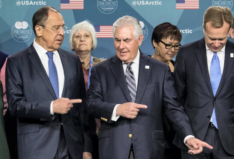 US Secretary of State Rex Tillerson (C) shows the way out to Russian Foreign Minister Sergei Lavrov (L) after posing for a family photo at the Arctic Council meeting in Fairbanks, Alaska, on May 11, 2017. / AFP PHOTO / NICHOLAS KAMM