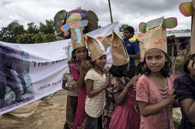 Rohingya children wear elephant hats they have made to mark World Elephant Day in the Rohingya refugee camp near Cox's Bazar, Bangladesh on 12 August 2018. Campbell MacDiarmid for The National