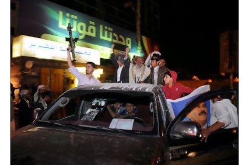 Yemeni men shout slogans celebrating the television appearance of their president, Ali Abdullah Saleh, in Sanaa on Thursday. Wadia Mohammed / EPA