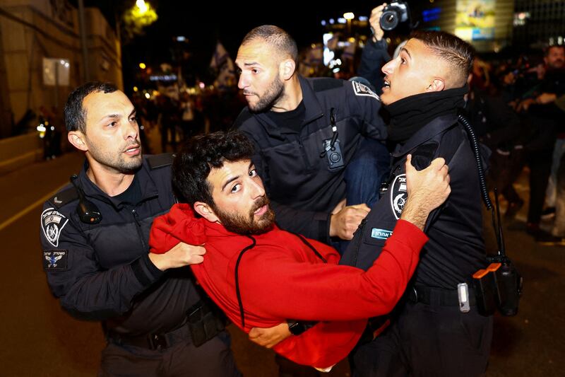 Police officers detain a man during a demonstration, as Israeli Prime Minister Benjamin Netanyahu's nationalist coalition government presses on with its contentious judicial overhaul, in Tel Aviv, Israel. Reuters