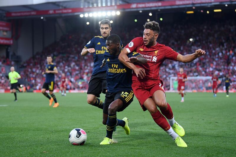 LIVERPOOL, ENGLAND - AUGUST 24: Ainsley Maitland-Niles of Arsenal and Alex Oxlade-Chamberlain of Liverpool battle for possession during the Premier League match between Liverpool FC and Arsenal FC at Anfield on August 24, 2019 in Liverpool, United Kingdom. (Photo by Laurence Griffiths/Getty Images)