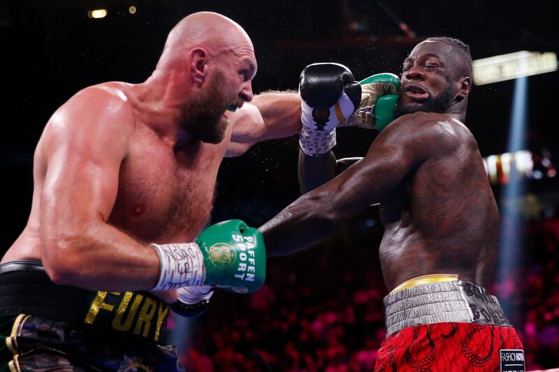 Tyson Fury lands a punch on American opponent Deontay Wilder during the heavyweight title fight in Las Vegas on Saturday, October 9. AP