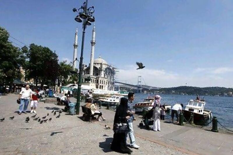 Tourists throng the Ottoman-era Ortakoy Mecidiye Mosque and Bosphorus Bridge in Istanbul. Turkey has become a hot destination for Arab tourists in recent years. Osman Orsal / Reuters