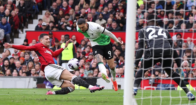 Manchester United's Diogo Dalot challenges Liverpool's Darwin Nunez. EPA