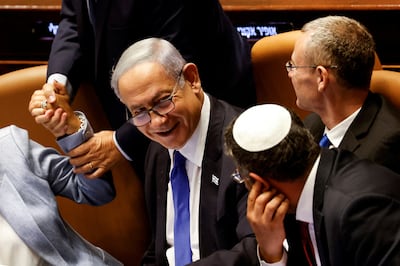 Prime Minister Benjamin Netanyahu smiles as Israel's government passes a bill that would limit Supreme Court powers. Reuters