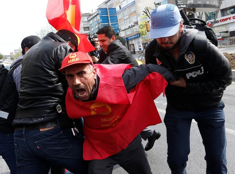 Plainclothes police officers detain a protester in Istanbul. Murad Sezer / Reuters