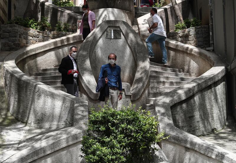 People wearing a face mask as they walk on famous Kamondo Stairs in Istanbul, Turkey.  EPA