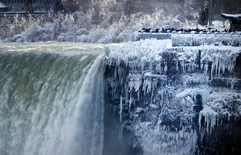 The banks around the Horseshoe Falls at Niagara Falls in Canada Ont are frozen.  Aaron Lynett / The Canadian Press via AP