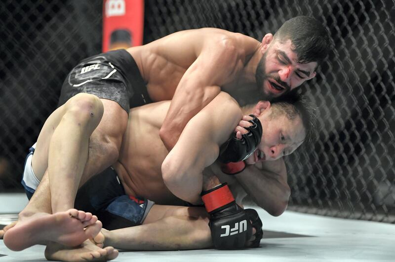 ABU DHABI, UNITED ARAB EMIRATES - JANUARY 23: (L-R) Amir Albazi of Iraq attempts to secure a rear choke against Zhalgas Zhumagulov of Kazakhstan during the UFC 257 event inside Etihad Arena on UFC Fight Island on January 23, 2021 in Abu Dhabi, United Arab Emirates. (Photo by Chris Unger/Zuffa LLC)