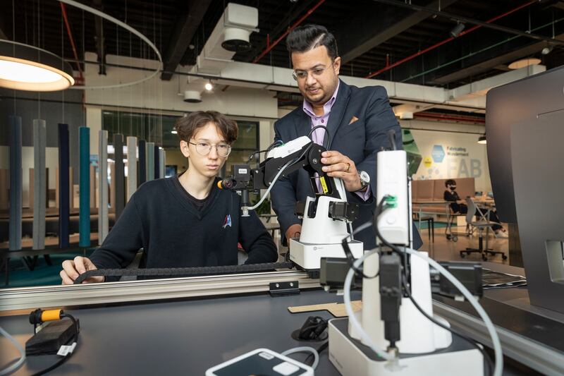 Mr Chakrabarty with a pupil at Dubai American Academy. Photo: Antonie Robertson / The National

