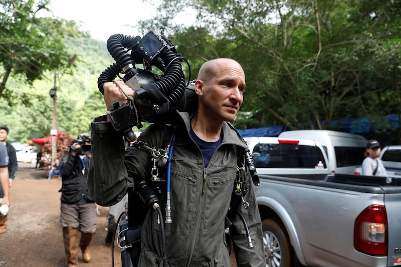 A foreign diver carries equipment as he goes in to Tham Luang cave complex. Soe Zeya Tun / Reuters