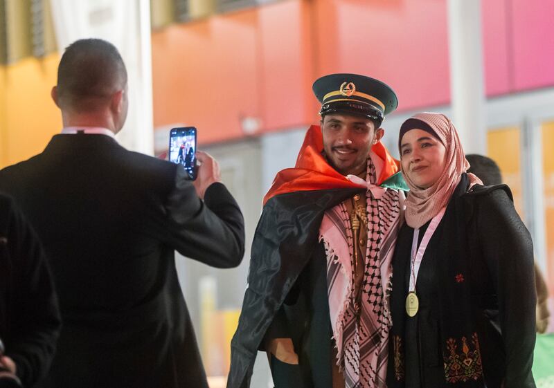 A graduate has her photo taken at the world's fair.