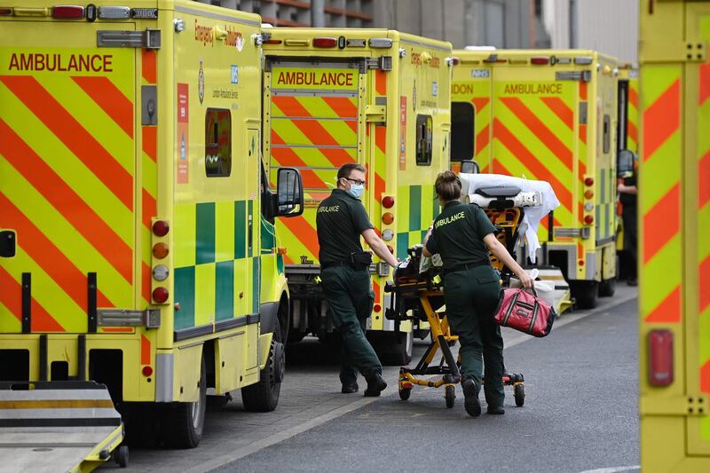 London Ambulance staff stretcher a patient from the ambulance into The Royal London Hospital in east London, on January 2, 2021. Health Services are under increasing pressure after record levels of daily lab-confirmed cases of Covid-19 has led to more patients being treated in hospital in England than during the initial peak of the outbreak in April. / AFP / DANIEL LEAL-OLIVAS
