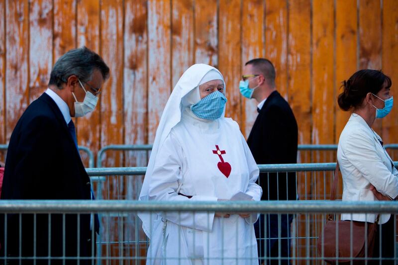 A nun who made 15,000 face masks during the coronavirus crisis queues outside the Grand Palais in Paris prior to a reception called by French health minister to honour about 800 health workers for their service during the pandemic.   AFP