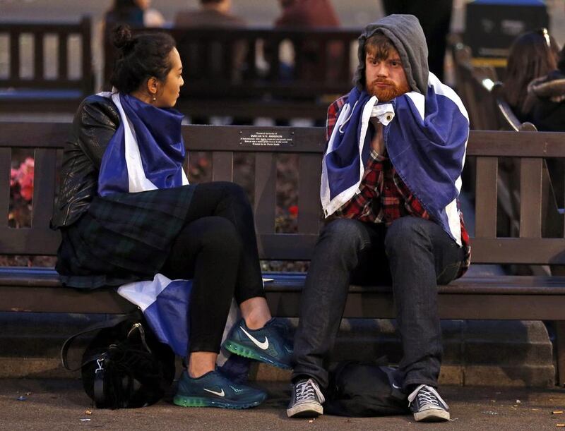 Dejected supporters from the “Yes” Campaign sit on a bench in George Square in Glasgow. Cathal McNaughton / Reuters