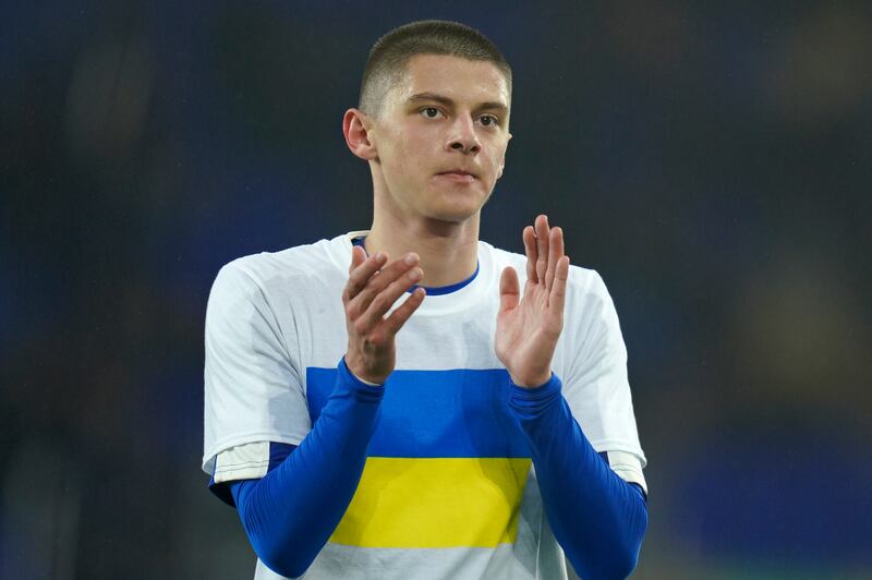 Everton's Vitaliy Mykolenko, from Ukraine, wearing the Ukrainian flag on his t-shirt, applauds before the FA Cup 5th round match between against Boreham Wood at Goodison Park. AP