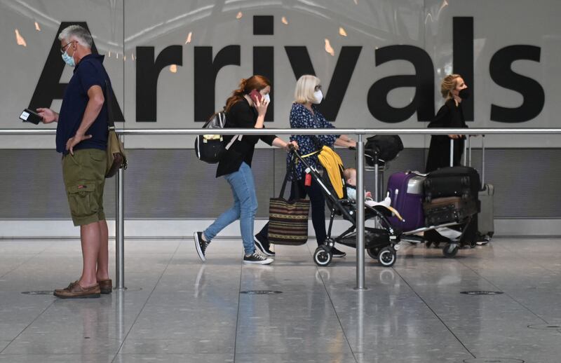 Passengers arrive at Heathrow Airport's Terminal 5 in London. AFP