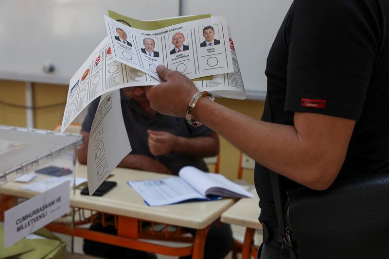 A man holds a ballot at a polling station in Hatay. Reuters