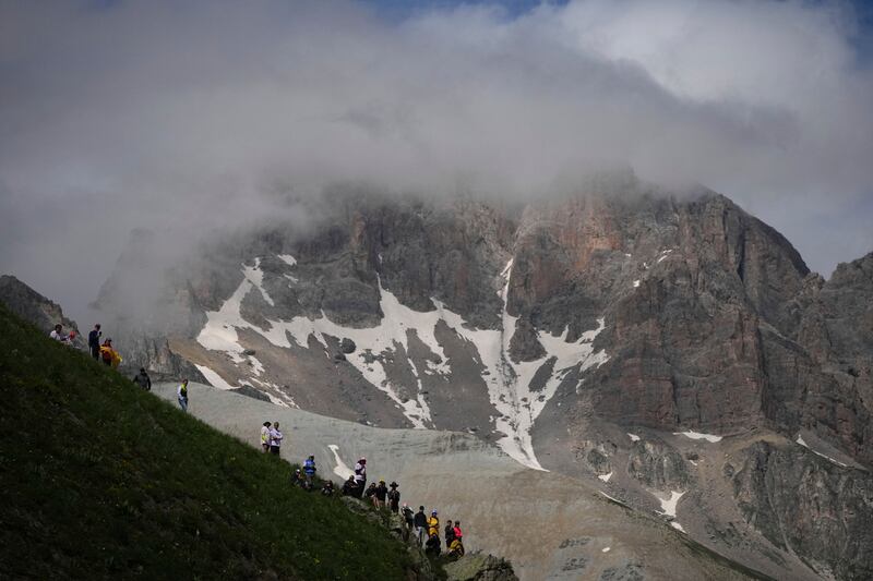 Spectators wait for the riders to pass in the Col du Galibier. AP 