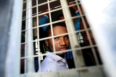 A Rohingya Muslim man looks out from inside a police vehicle, after he and others attended a court hearing on charges of illegally travelling without proper documents, in Pathein, Ayeyarwady, Myanmar December 20, 2019. Reuters