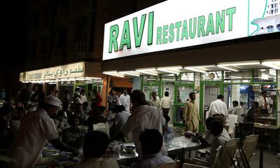 DUBAI, UNITED ARAB EMIRATES – Mar 24: People enjoying food in the evening at Ravi restaurant in Al Satwa in Dubai. (Pawan Singh / The National) For Personal Finance. Story by Daniel Bardsley  *** Local Caption ***  PS03- RAVI RESTAURANT.jpg