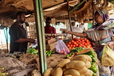 A woman buys vegetables at a market in Khartoum on Saturday. AFP