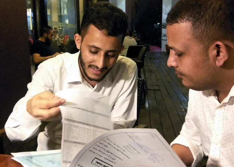 Yemeni Rafek Ahmed Mohammed Al-Sanani (R), 22, and Abdel Rahman Zaid, 26 look through documents as they speak with Reuters in Serdang, on the outskirts of Kuala Lumpur, Malaysia July 20, 2017. Picture taken July 20, 2017. REUTERS/Rozanna Latiff