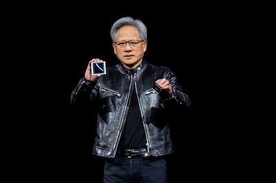 Jensen Huang displays the Blackwell chip next to the Hopper. Bloomberg