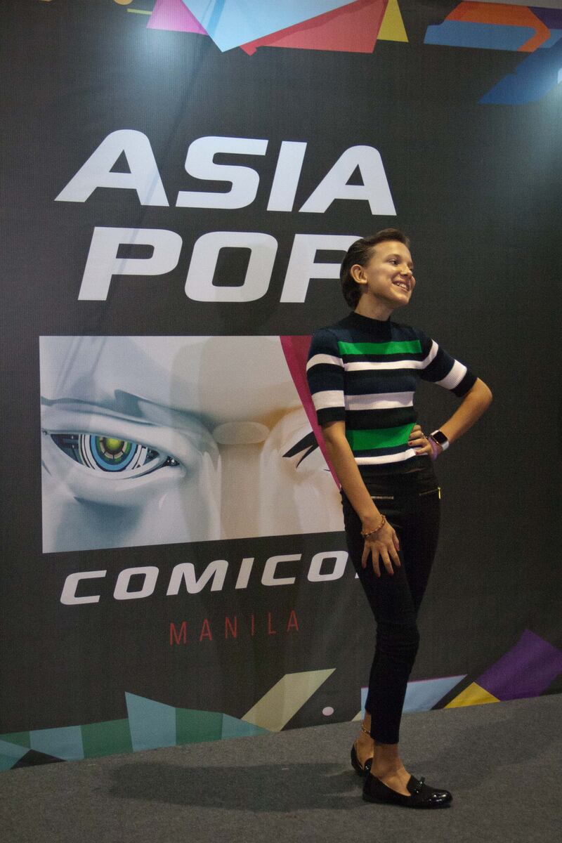 Millie Bobby Brown, wearing a striped green shirt and black jeans, attends Asia Pop Comic Con 2016 in Manila, Philippines, on August 28, 2016. Getty Images 