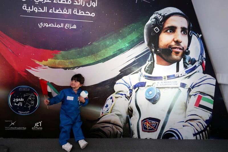 A child holds a miniature version of Suhail while attending the live screening of Maj Al Mansouri's launch. Chris Whiteoak / The National
